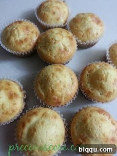 Freshly baked coconut cupcakes in paper liners