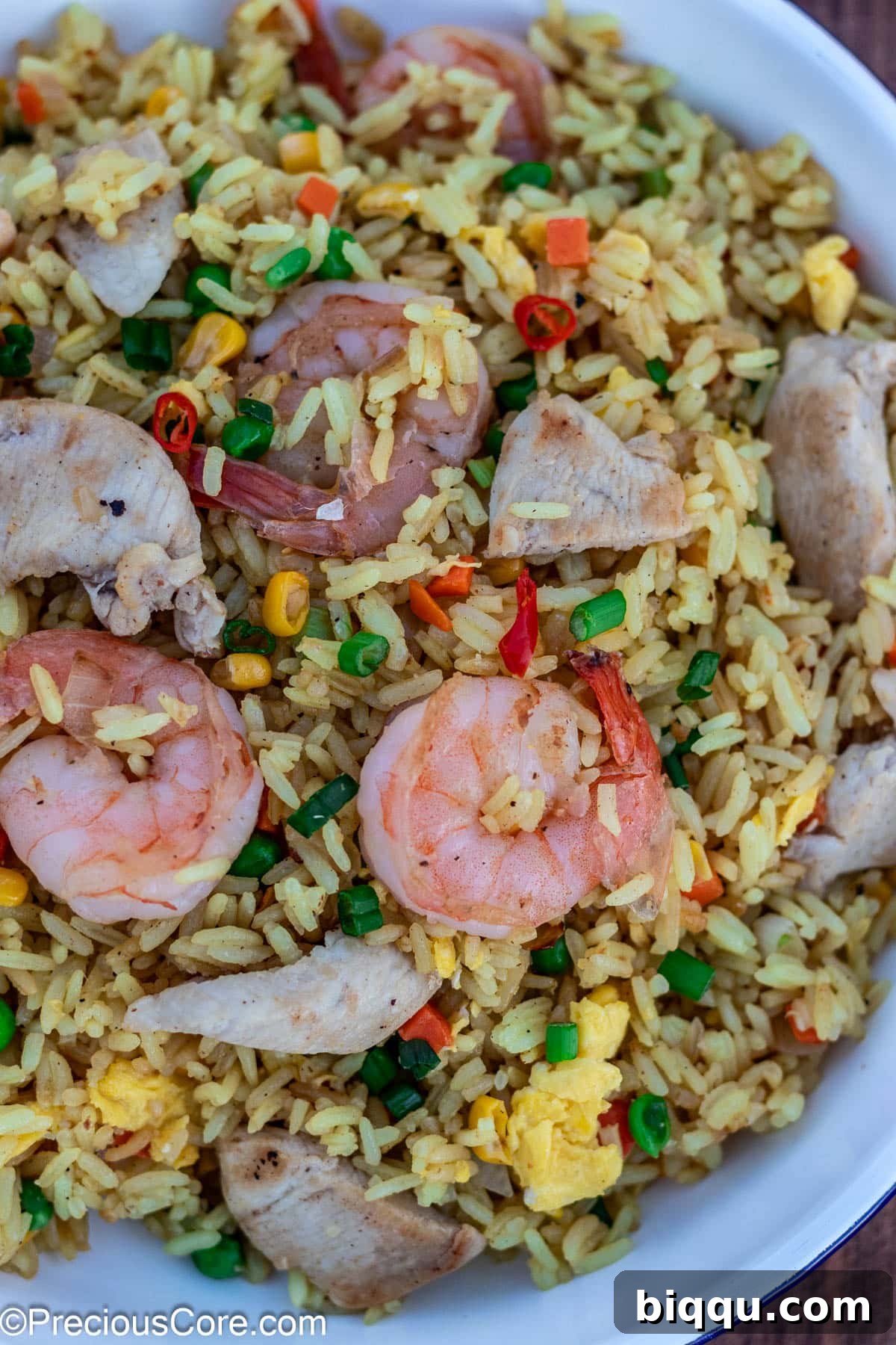 A close-up shot of the finished shrimp and chicken fried rice, highlighting the individual grains and ingredients.