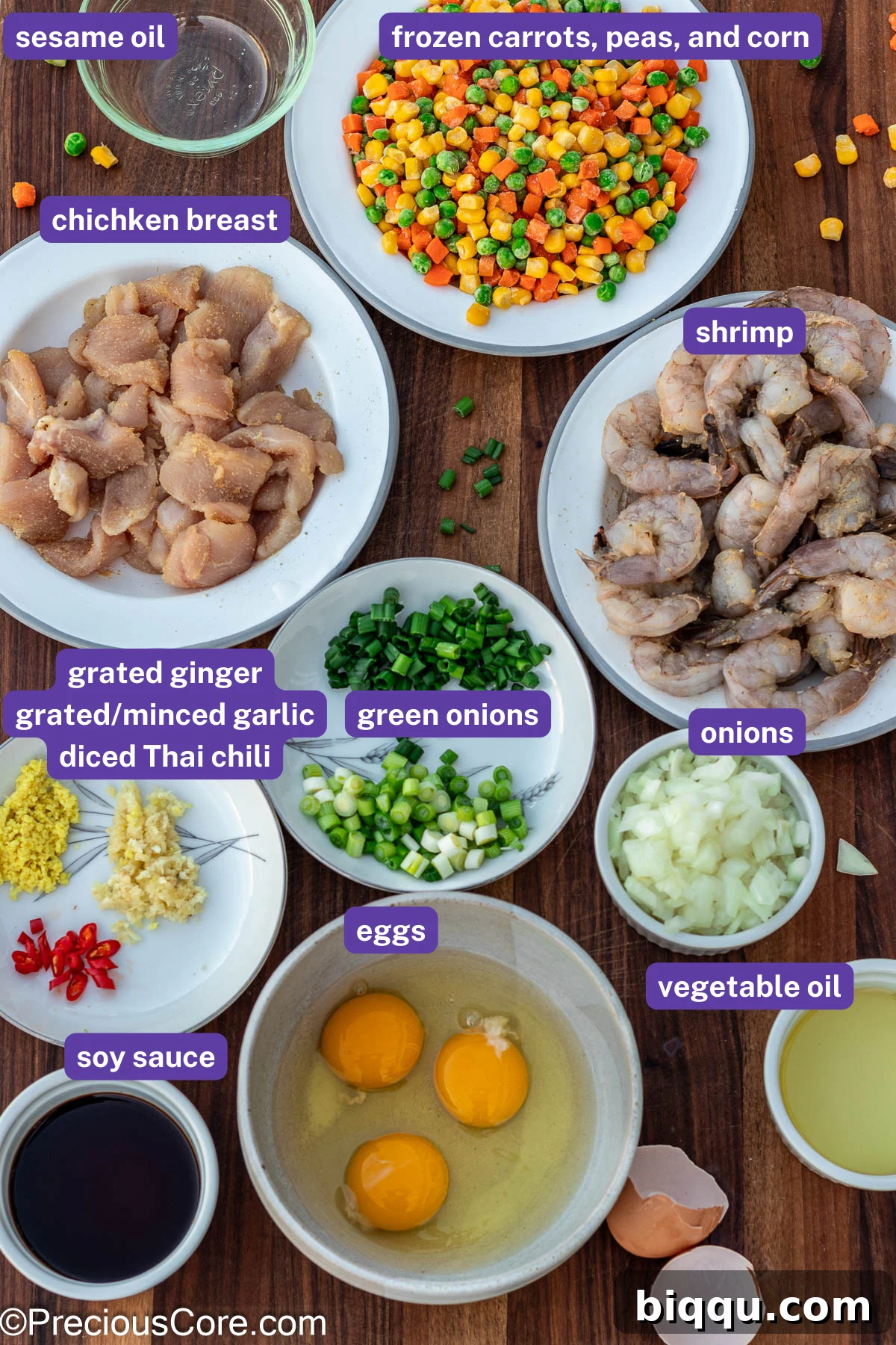 An array of fresh ingredients for fried rice, including chicken, shrimp, vegetables, and seasonings, all clearly labeled.