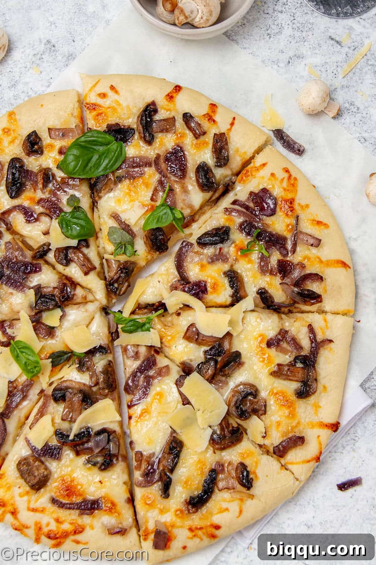 Pizza topped with mushrooms and fresh basil.