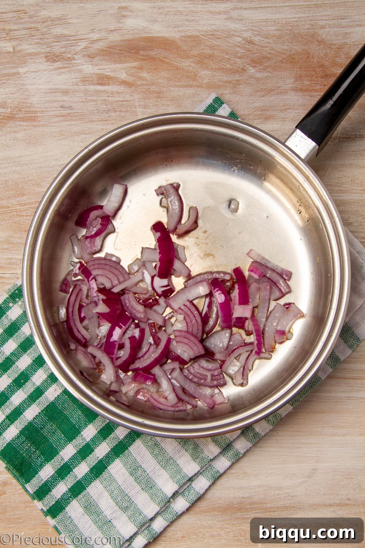 Sautéing onions in a pan.
