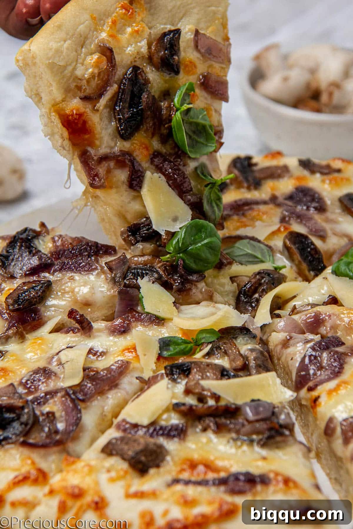 Grabbing a slice of mushroom pizza.
