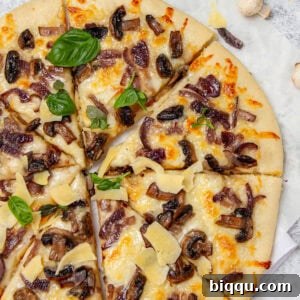 Pizza topped with mushrooms and fresh basil.