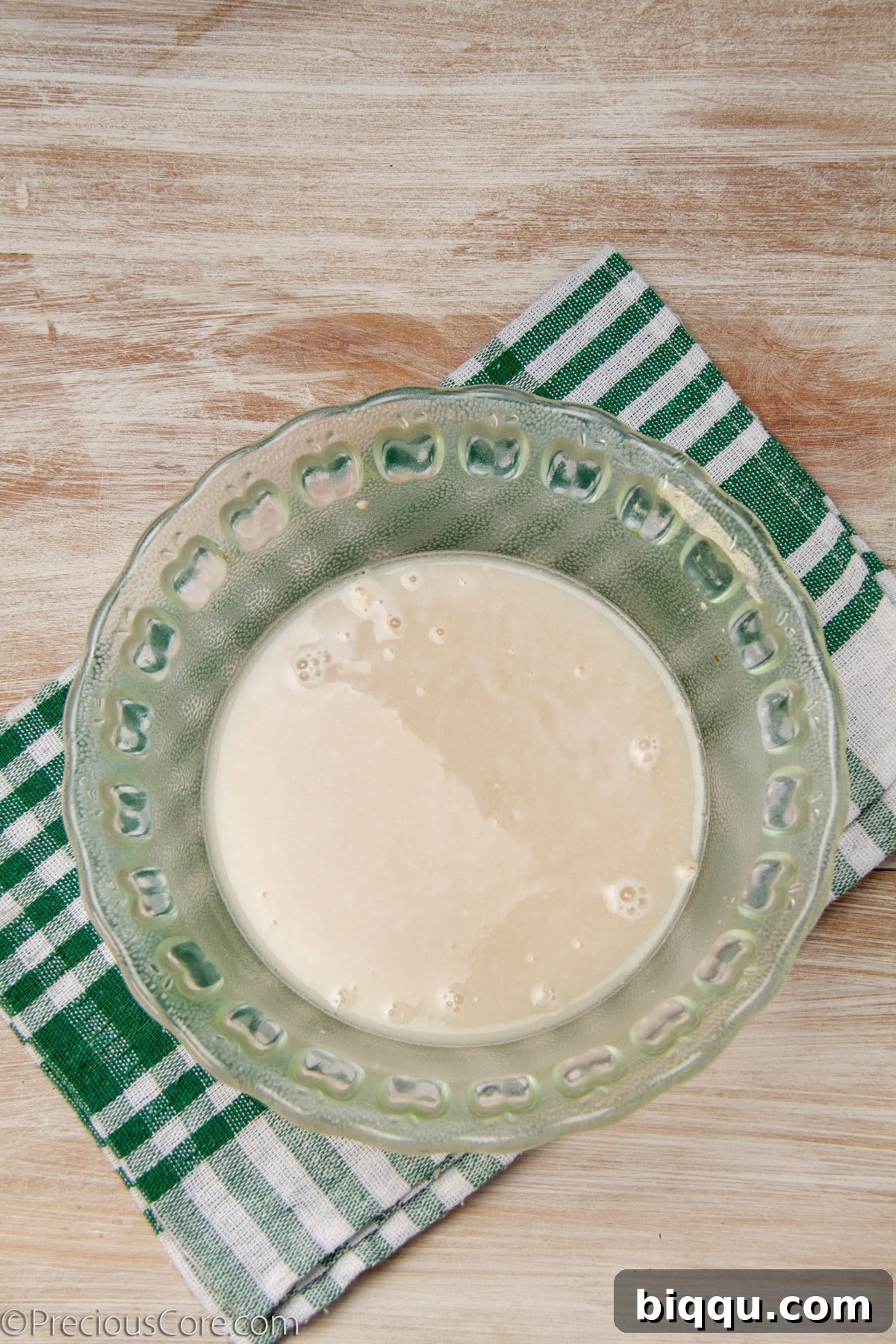Yeast dissolved in a bowl of warm water.