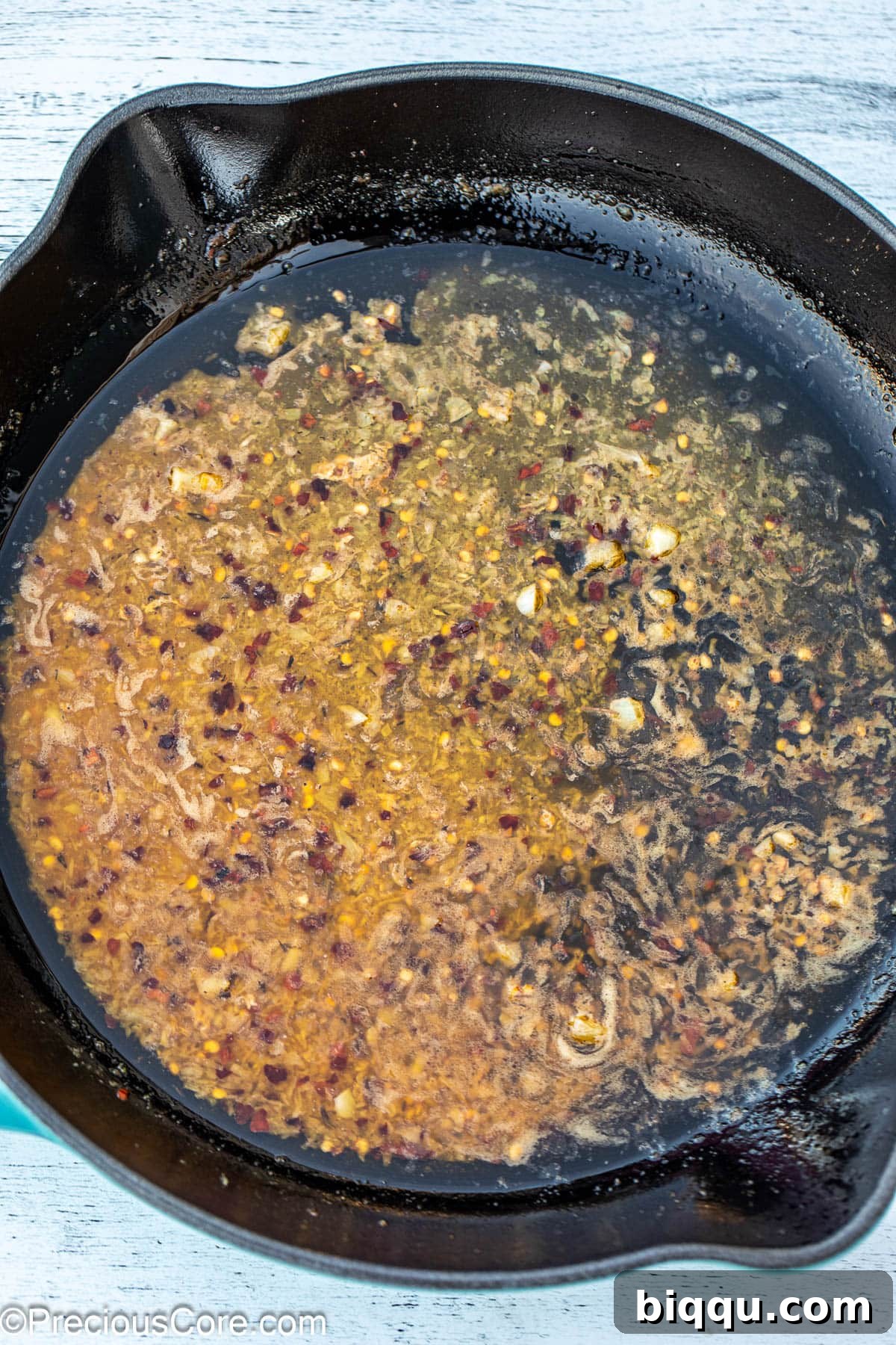 Melted butter combined with minced garlic, gently sizzling in a skillet, filling the air with aroma.