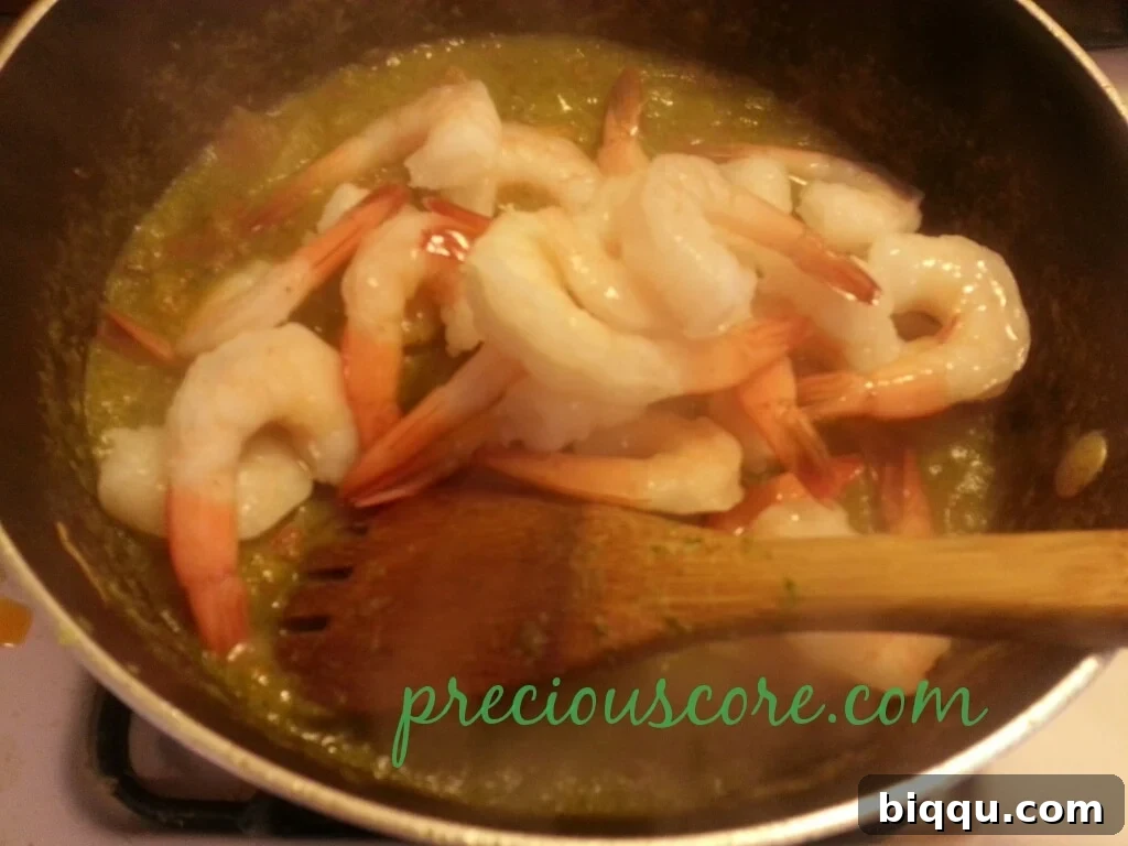 Incorporating the Colorful Vegetables Mixed vegetables added to the pan with shrimps and sauce.