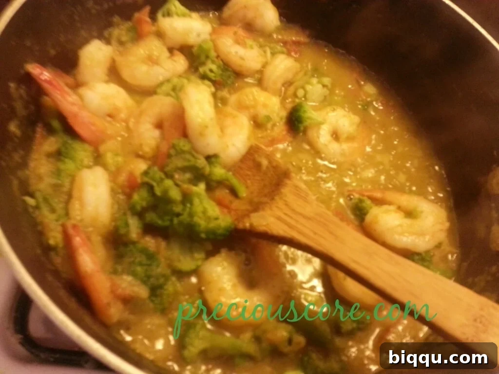 Final Simmer for Perfect Texture and Flavor The complete shrimp and vegetable stir fry simmering together in the pan.