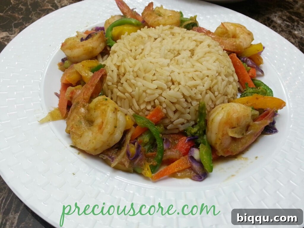 Shrimp Stir Fry with Healthy Brown Rice A plate of shrimp and vegetable stir fry served with brown rice.