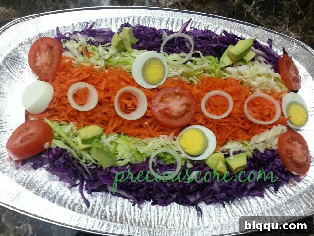 Beautifully arranged Cameroonian Cabbage Salad with various vegetables and egg, ready to be dressed