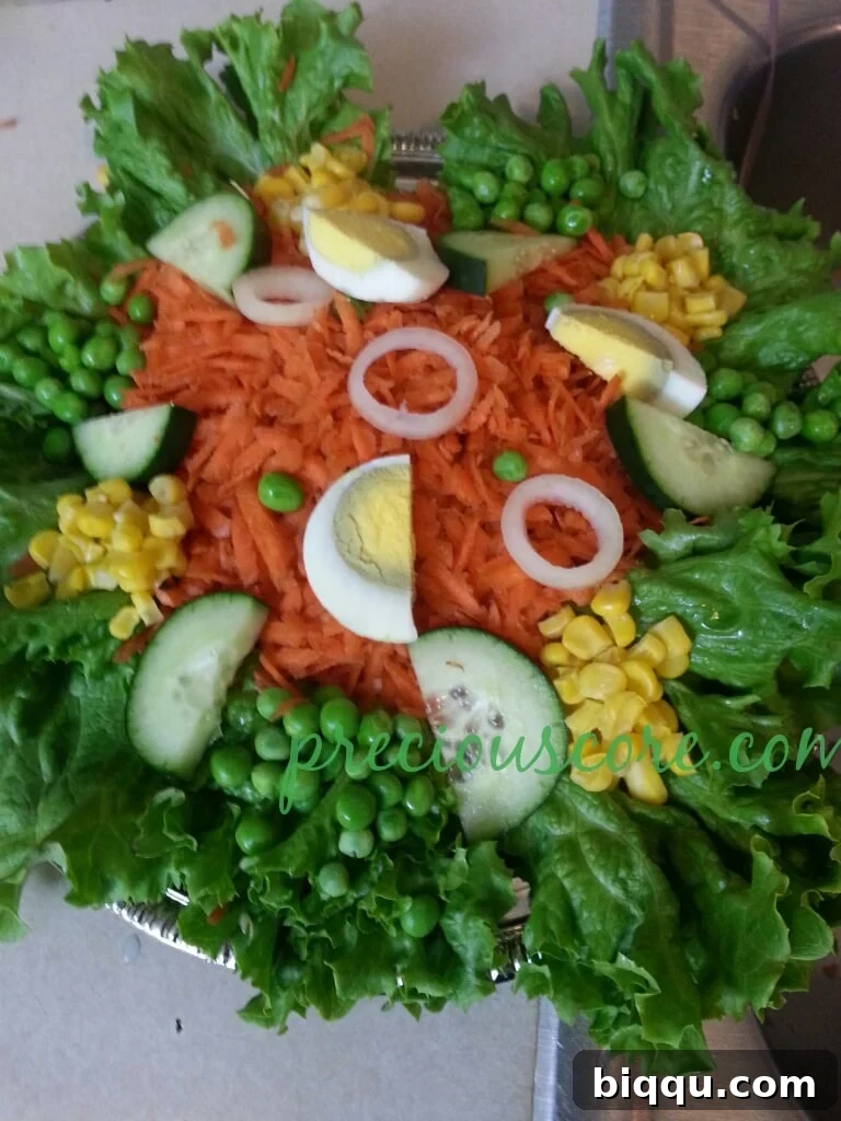Exquisite Cameroonian Lettuce Salad with fresh vegetables and egg, perfectly arranged