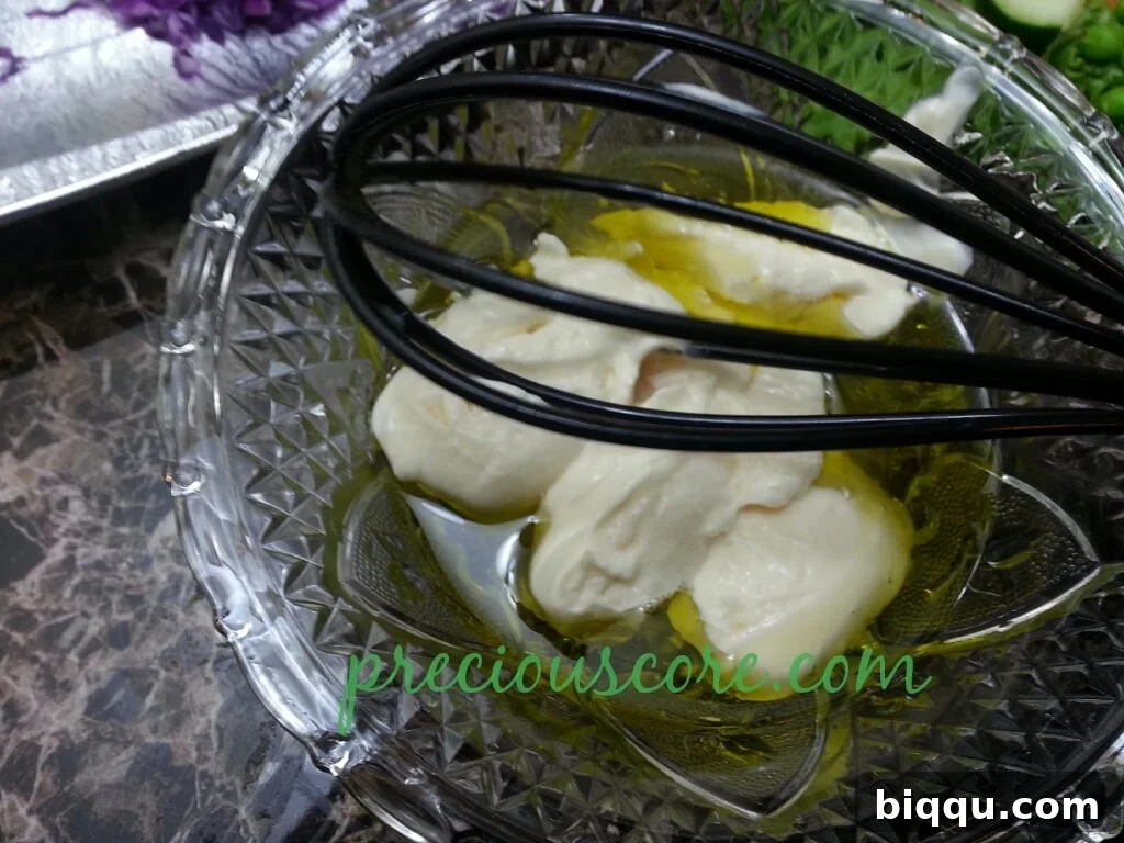 Mayonnaise added to the salad dressing ingredients, completing the creamy base
