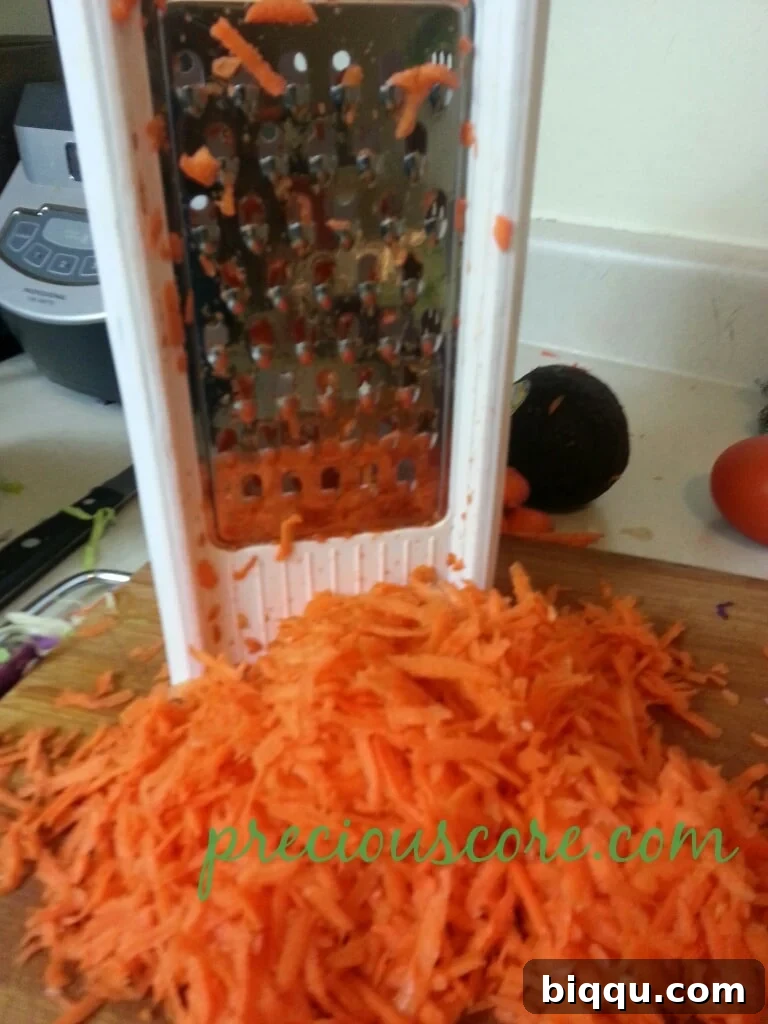 Neatly shredded carrots, ready to add sweetness and color to the salad