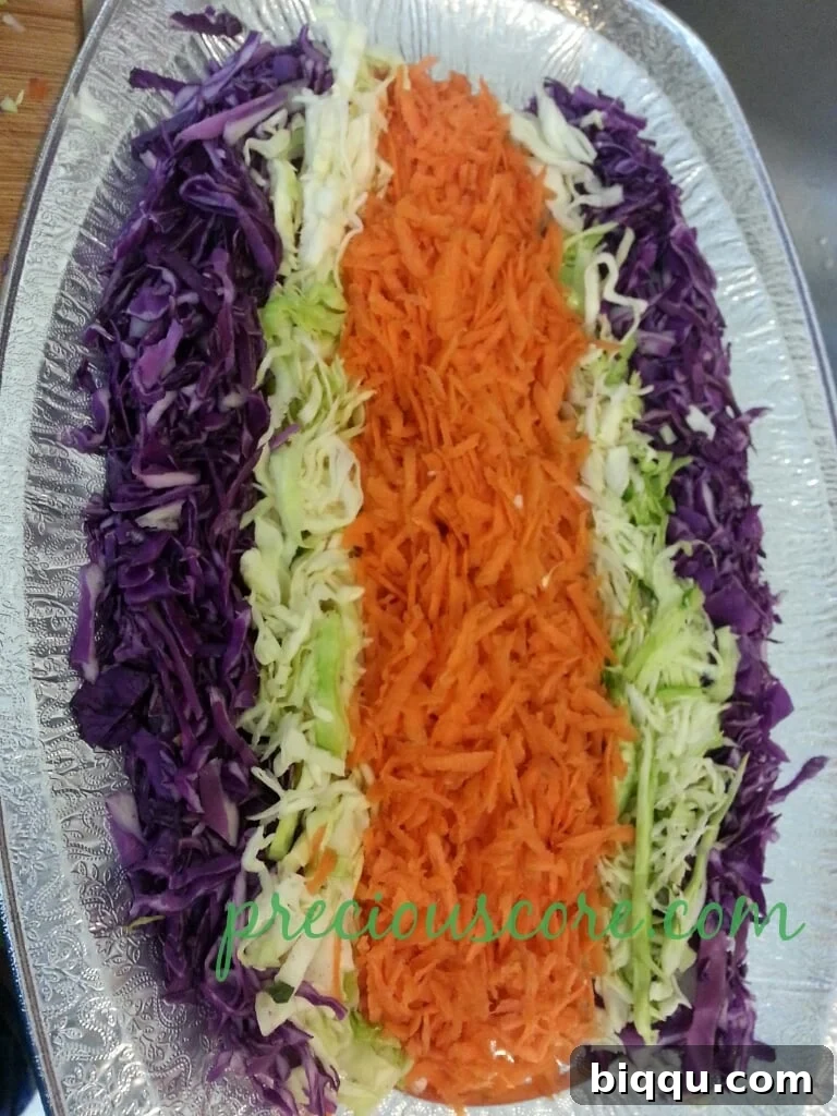 Shredded carrots beautifully arranged on a salad platter, forming a vibrant layer