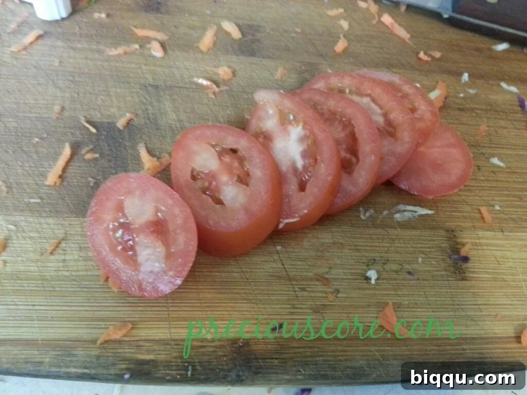 Perfectly sliced ripe tomato, ready to be added to the salad