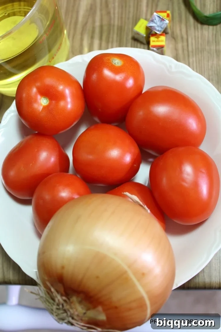 Tomatoes and onion in a bowl.