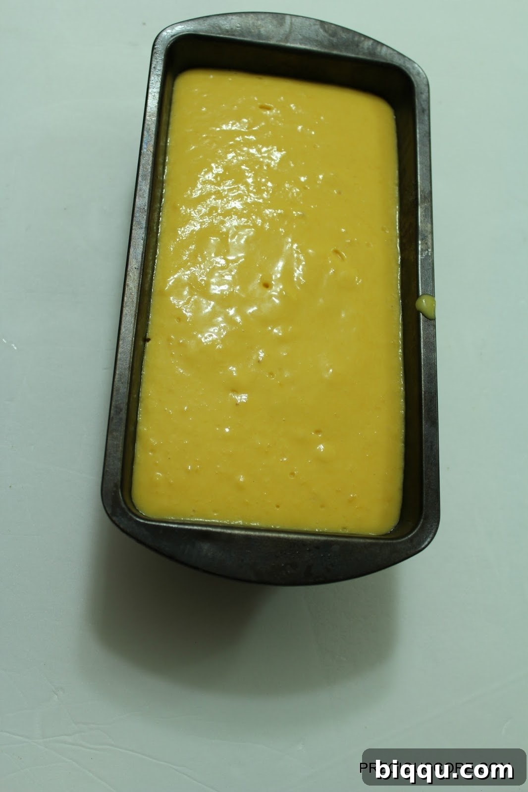 Mango sorbet mixture in a loaf pan, ready for freezing