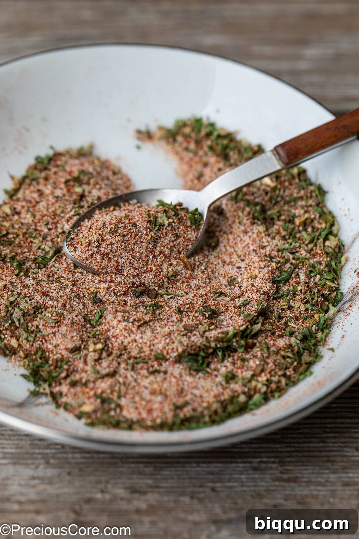 A spoon grabbing some of the best seasoning for French fries, showcasing the rich blend of spices.