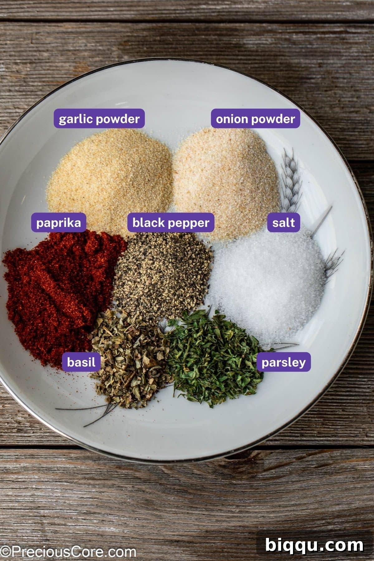 A collection of the best spices for French fries, including garlic powder, onion powder, paprika, basil, and parsley, each labeled for clarity.