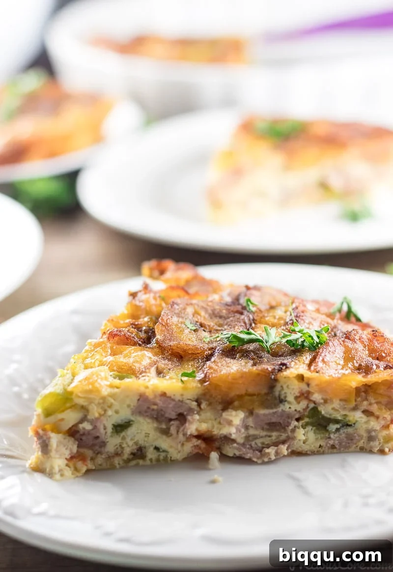 A triangular slice of Plantain Frittata on a white plate.
