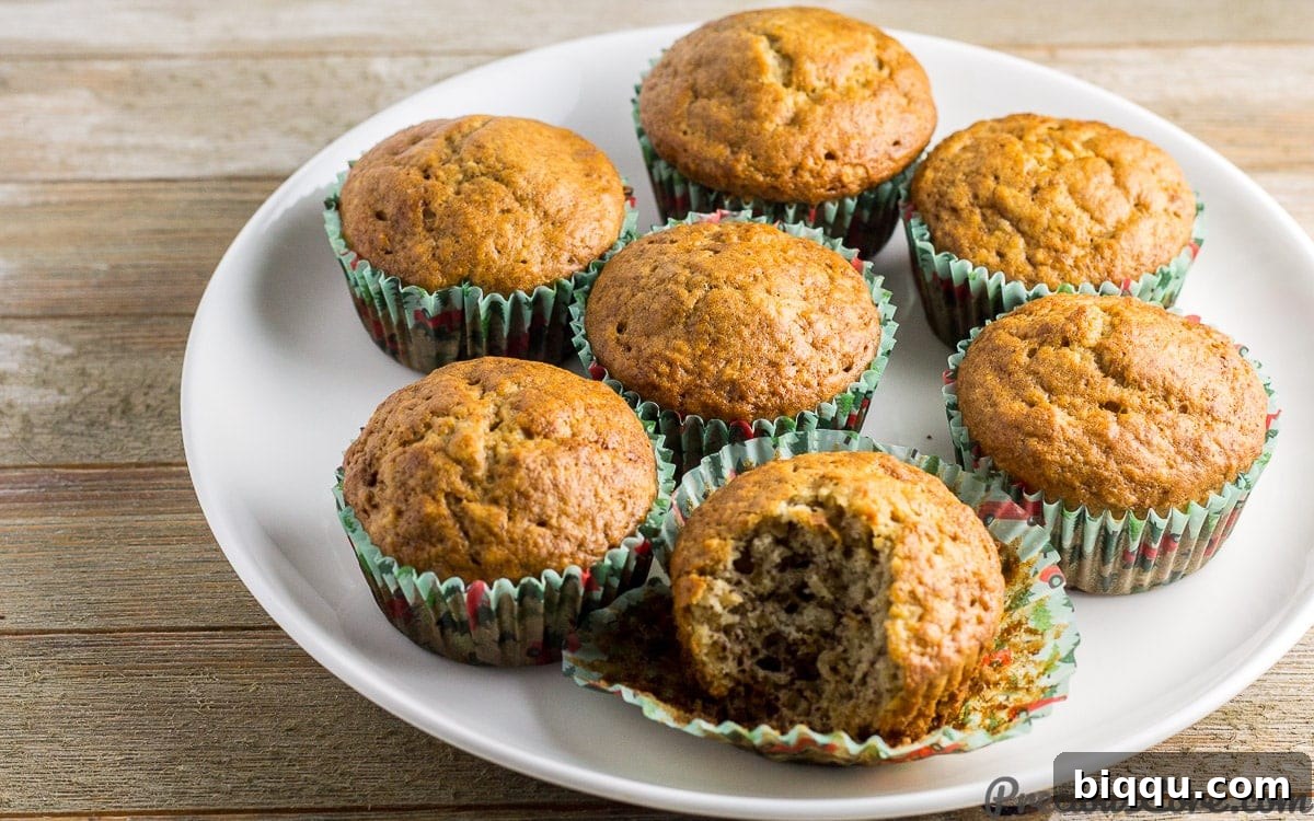 Cameroon banana cakes on a white plate, one missing a bite.