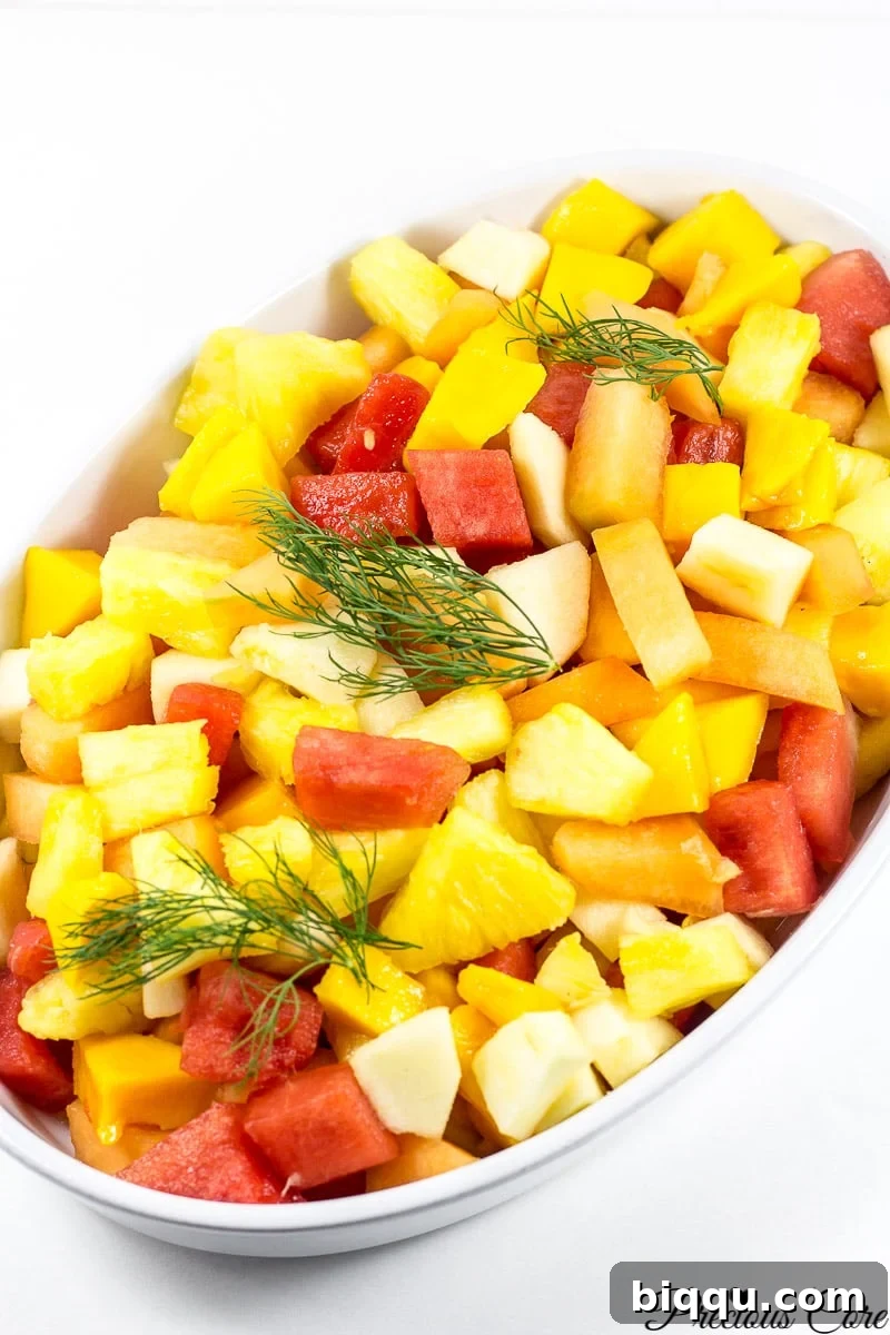 Cameroonian fruit salad in a white serving bowl.