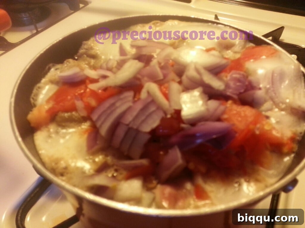 Gizzards boiling with tomatoes and peppers