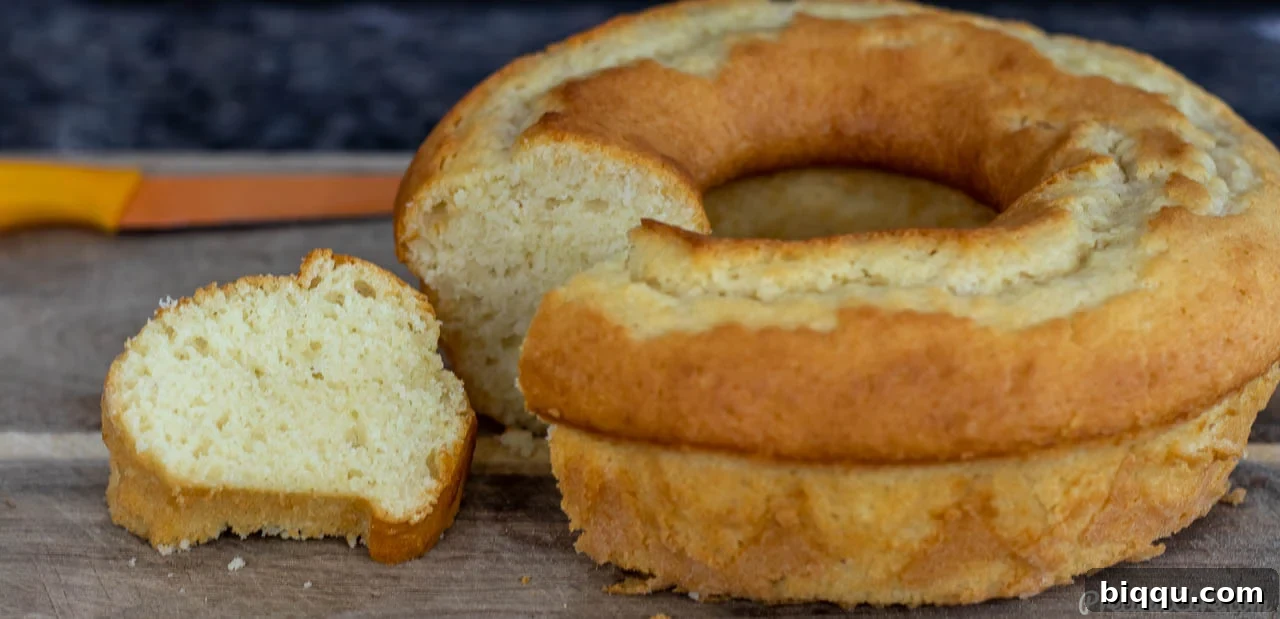 A slice of moist yogurt cake on a cutting board, ready to be served.