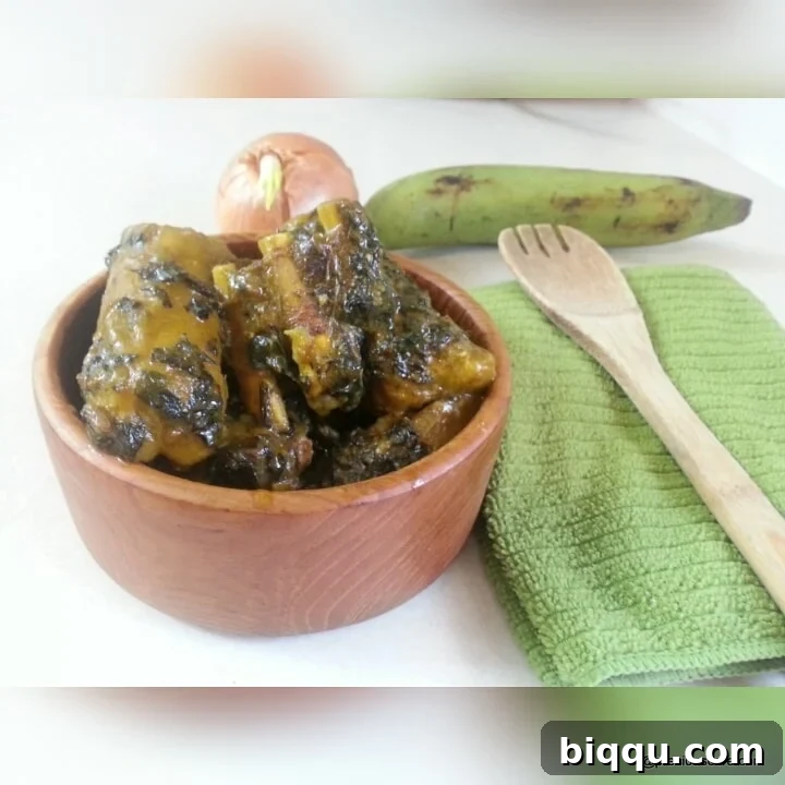 A freshly cooked pot of Born House Planti, rich with palm oil and unripe plantains, symbolizing Cameroonian home cooking.