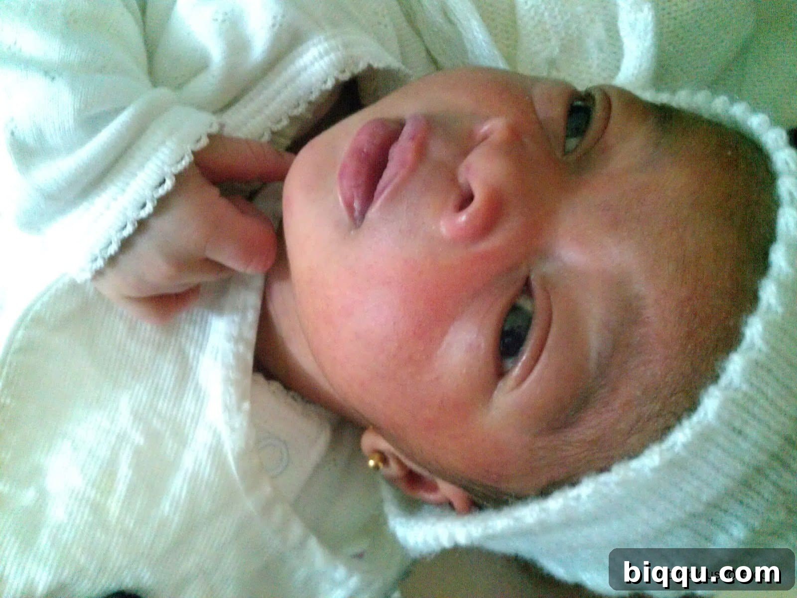 Newborn baby resting peacefully in a cot
