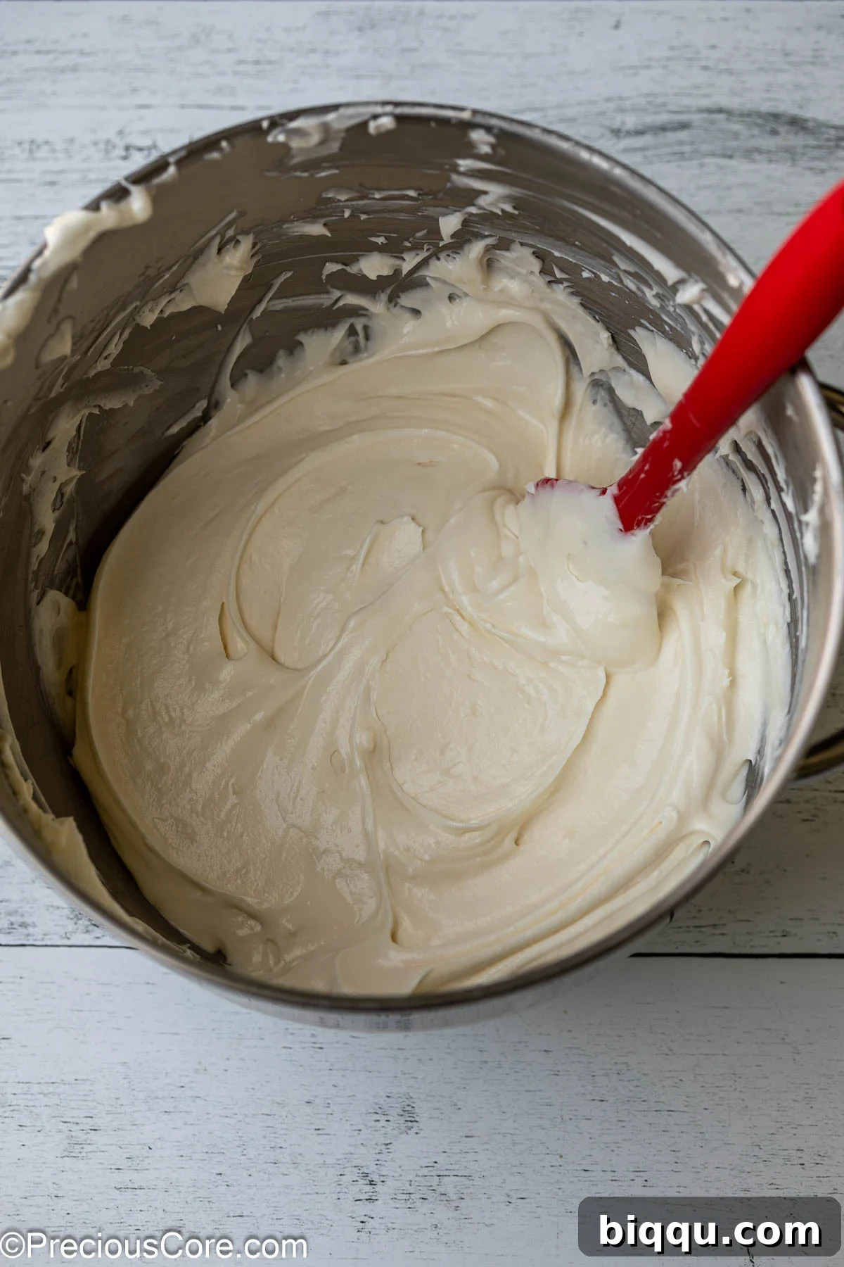 Velvet Dream Cake Without Buttermilk 12 Smooth and fluffy whipped cream cheese frosting in a glass bowl, ready to adorn the red velvet cake.