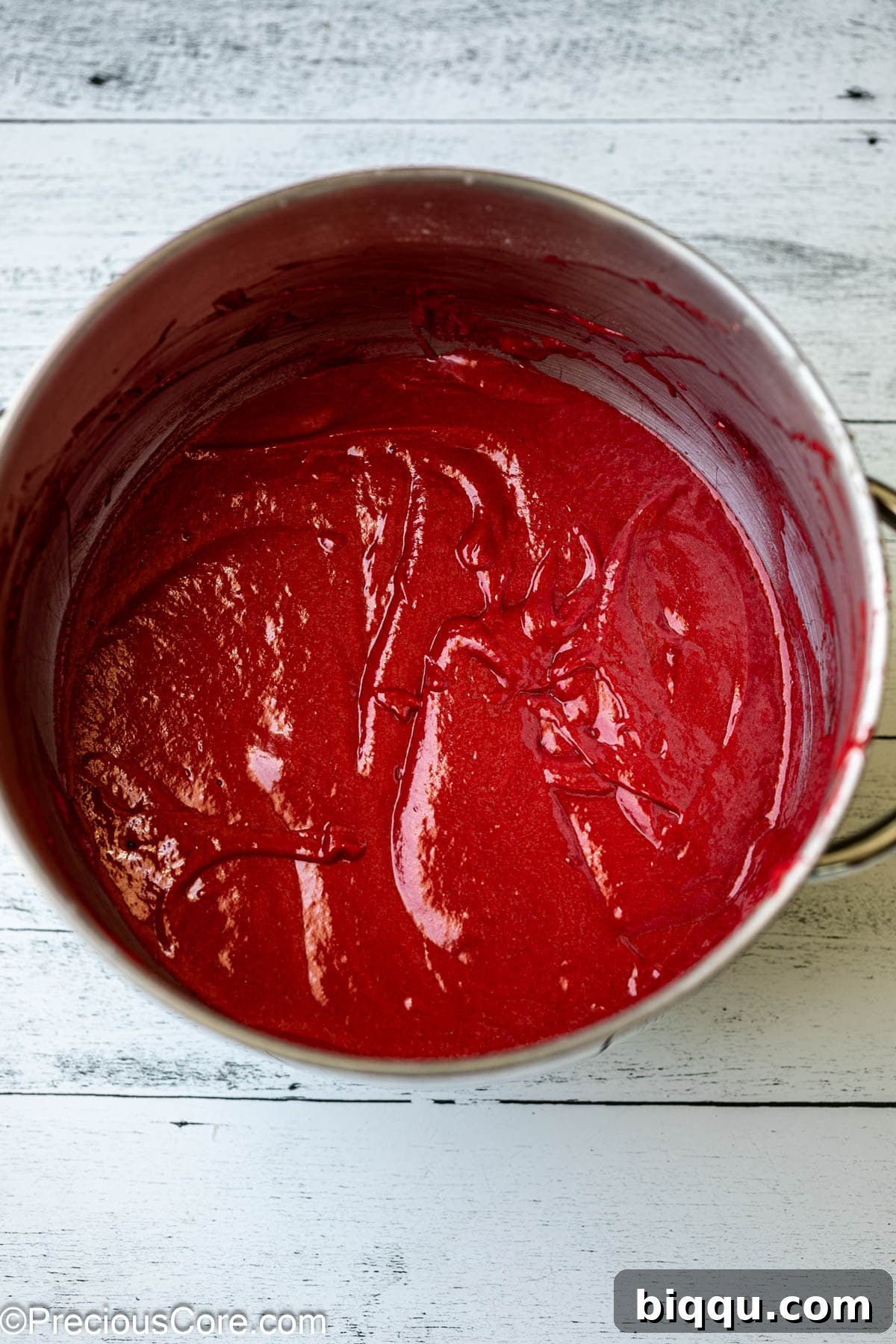 Velvet Dream Cake Without Buttermilk 9 Vibrantly red red velvet cake batter in a mixing bowl, ready for baking.