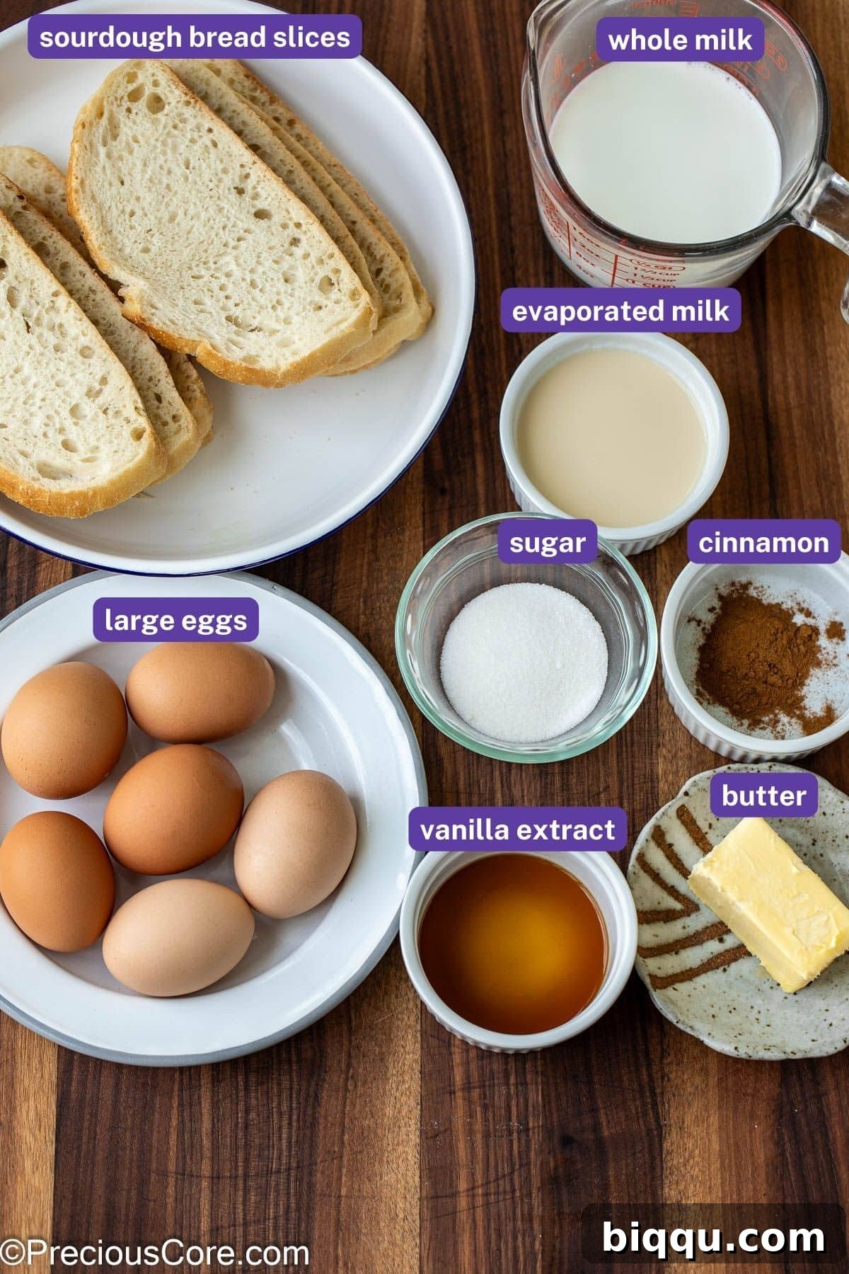 Neatly measured out ingredients for Sourdough French Toast, including eggs, milk, sugar, and cinnamon, arranged on a kitchen counter.
