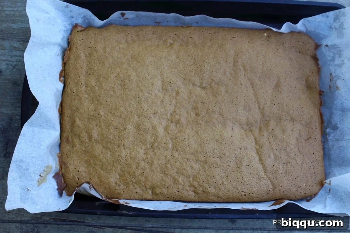 A perfectly baked pumpkin cake, golden and ready for rolling.