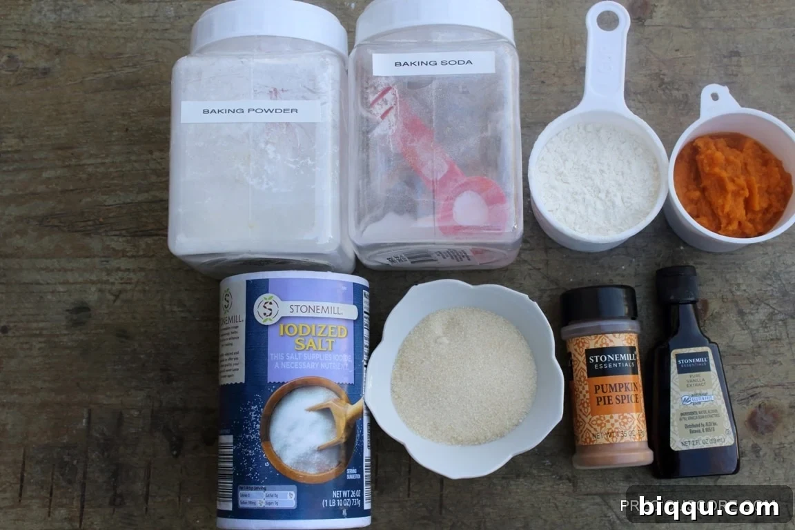 Cake ingredients including baking powder, salt, and pumpkin pie spice, laid out for baking.