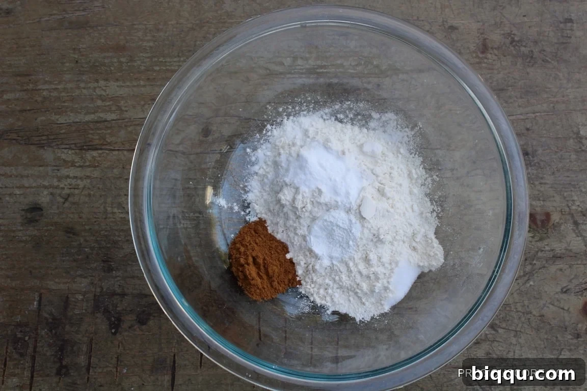 Dry cake ingredients in a glass mixing bowl, perfectly combined.