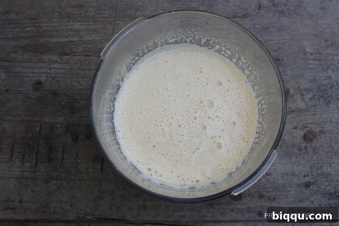 Beaten eggs, sugar, and vanilla, showing a thick and creamy texture.