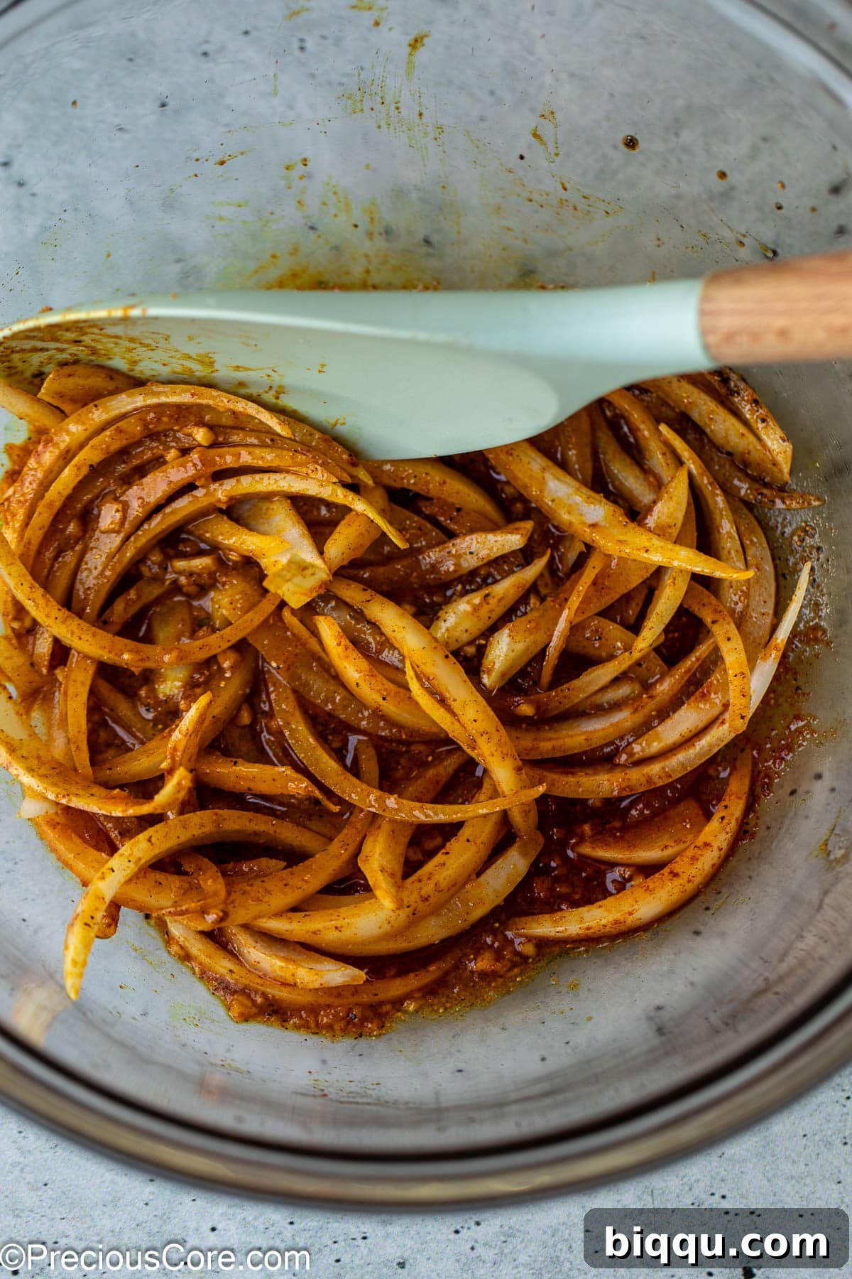 Onions and marinade ingredients in bowl.