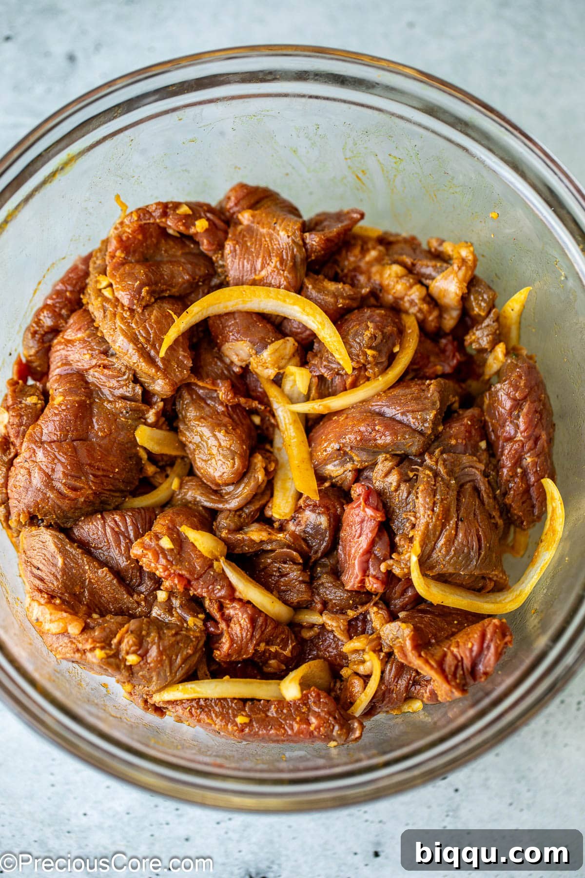 Marinating beef for beef shawarma in a bowl.
