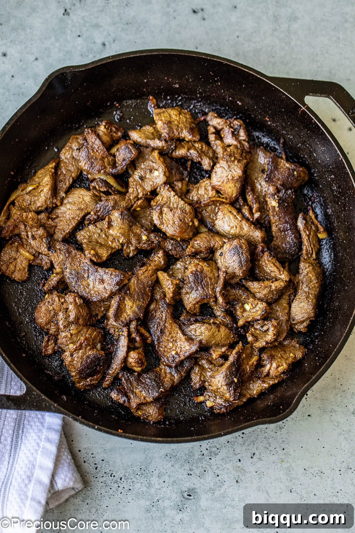 Cooked beef in a cast iron pan.