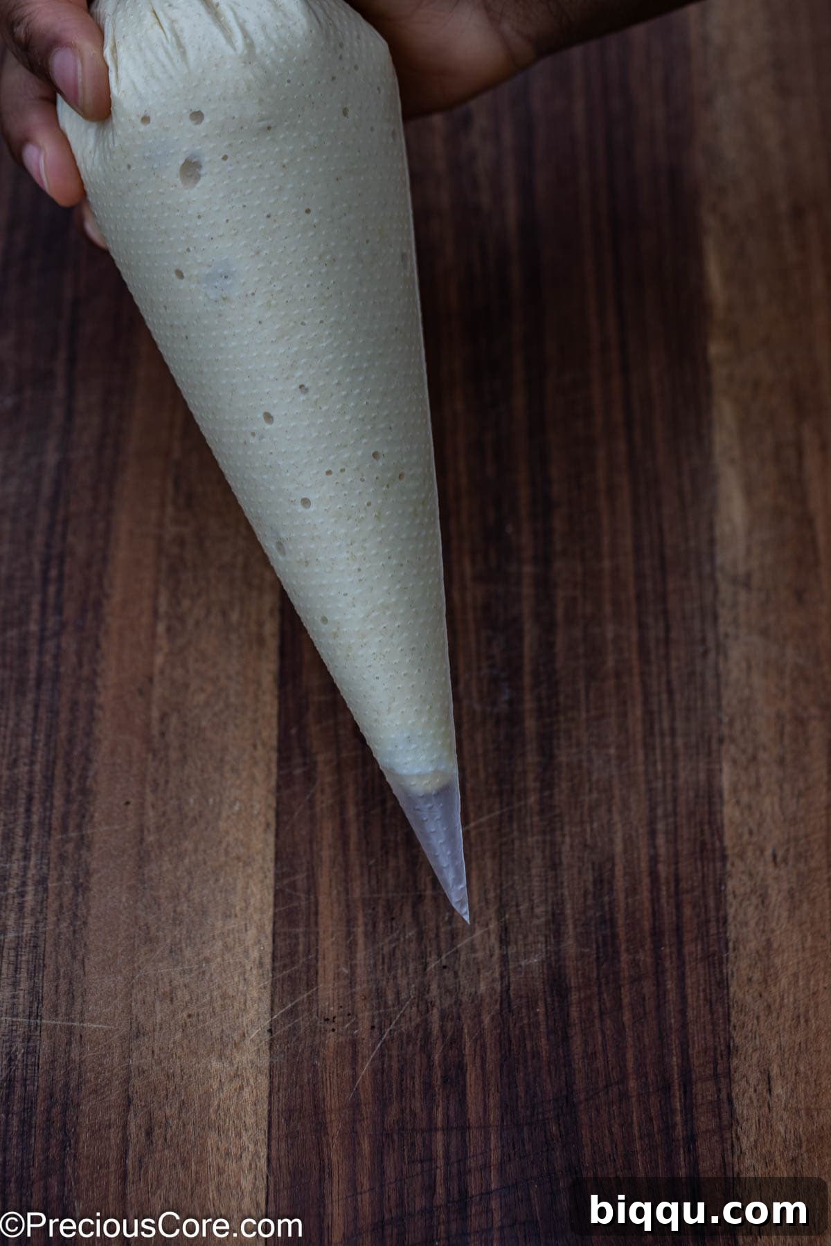 Pancake batter poured into a piping bag, ready for shaping.