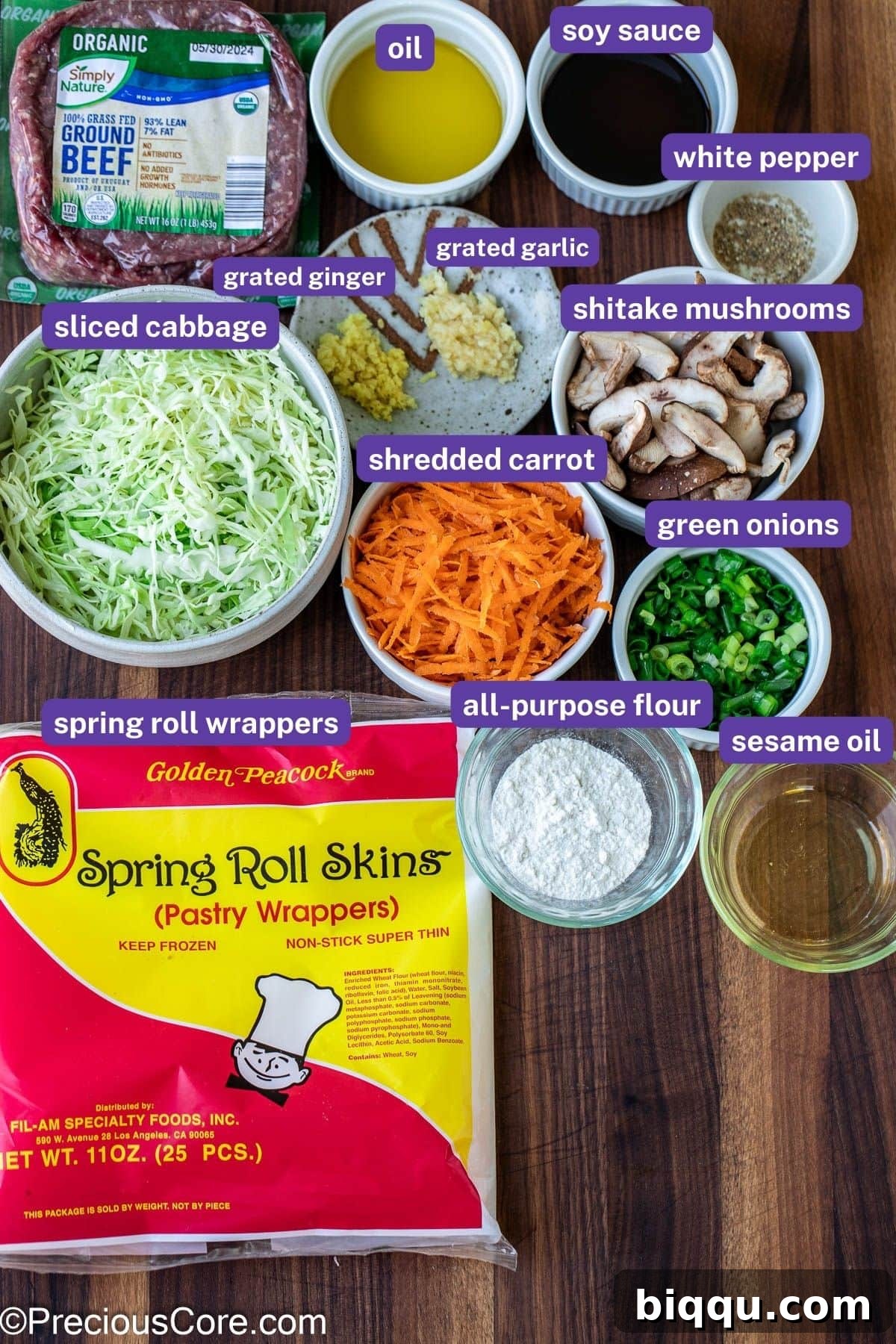 Savory Beef Spring Rolls 6 A selection of fresh ingredients laid out for homemade beef spring rolls, including ground beef, vegetables, and wrappers.