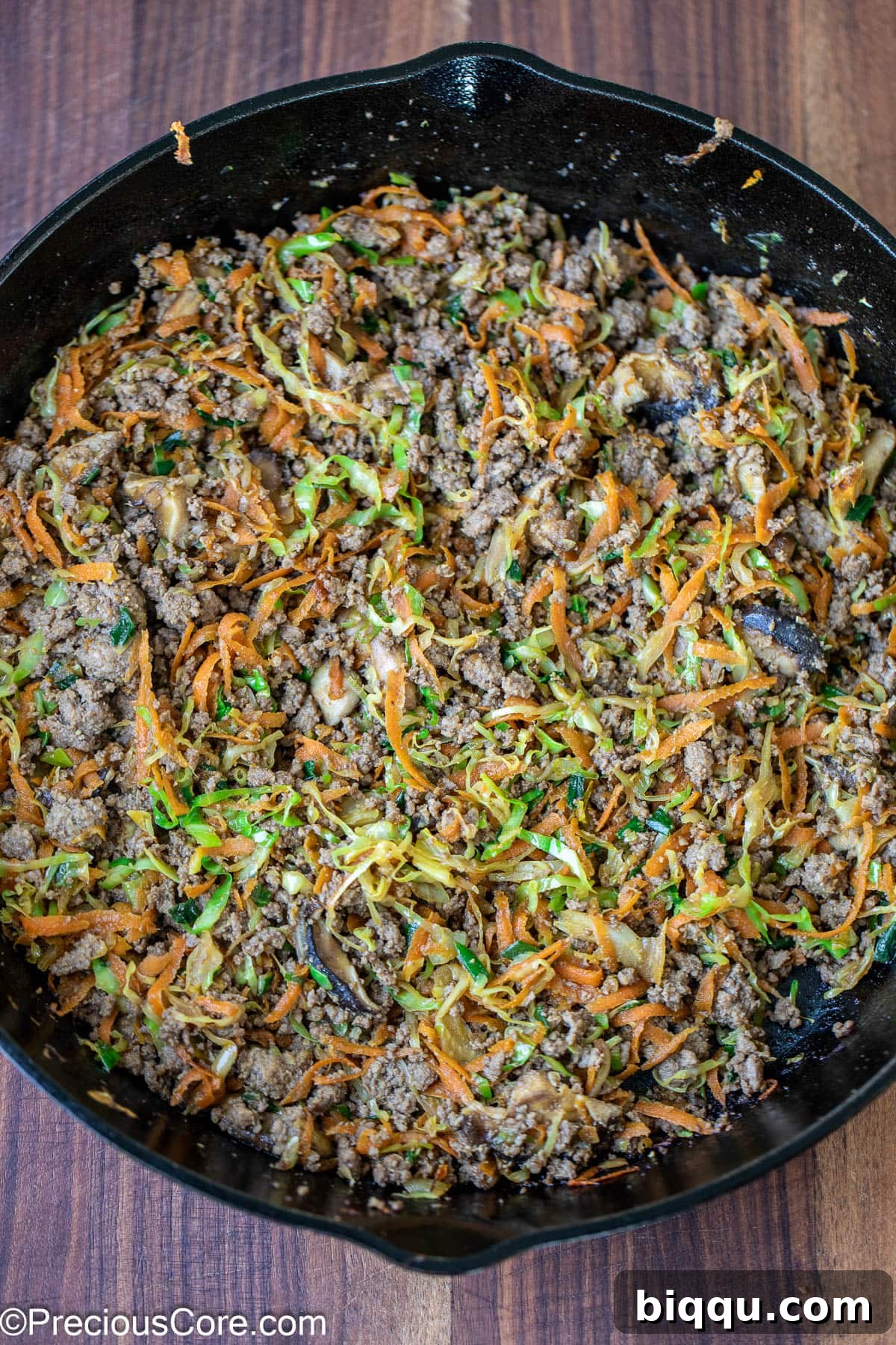 Savory Beef Spring Rolls 9 Cooked beef and vegetable filling in a skillet, mixed and ready.