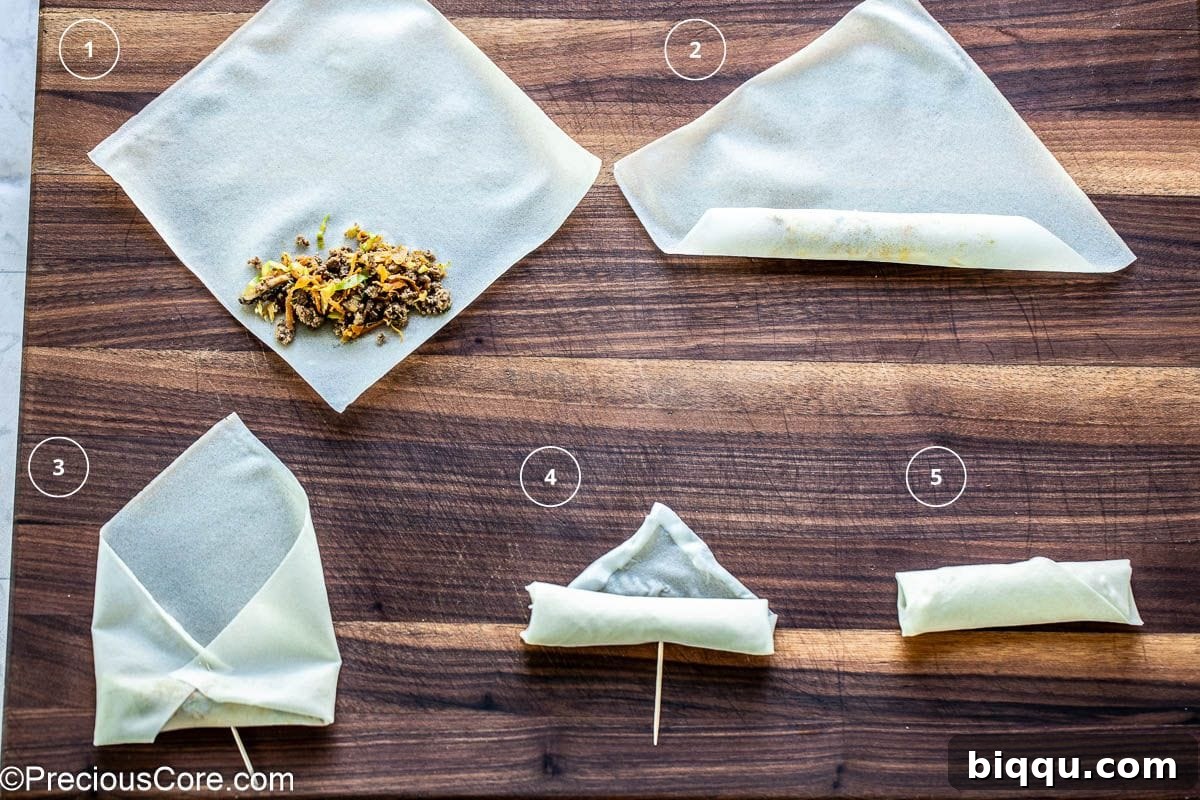 Savory Beef Spring Rolls 10 Step-by-step process of wrapping a beef spring roll on a white surface.