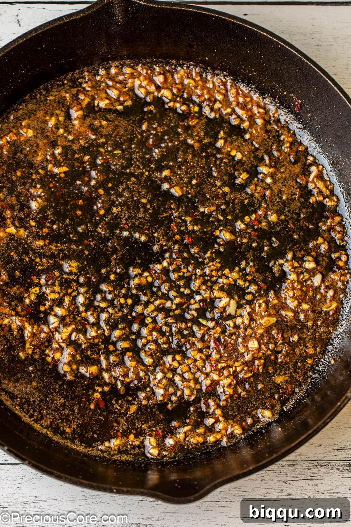 Melted butter and fresh minced garlic simmering in a skillet.