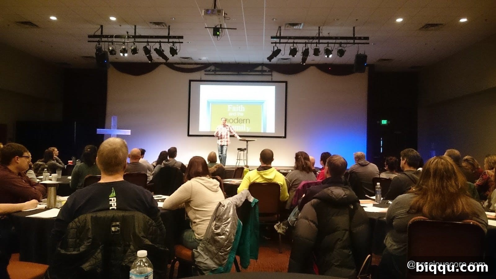 Parents engaging in vibrant discussions and networking at a seminar focused on faith and family values in contemporary society.