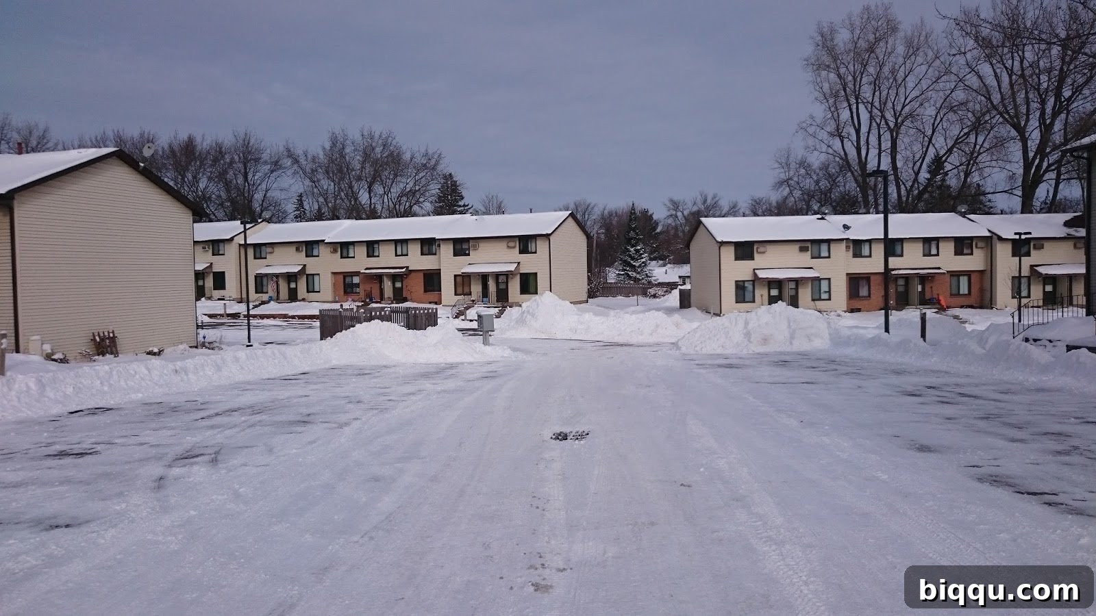 A clean, cleared neighborhood street after extensive snow removal, returning to normalcy.