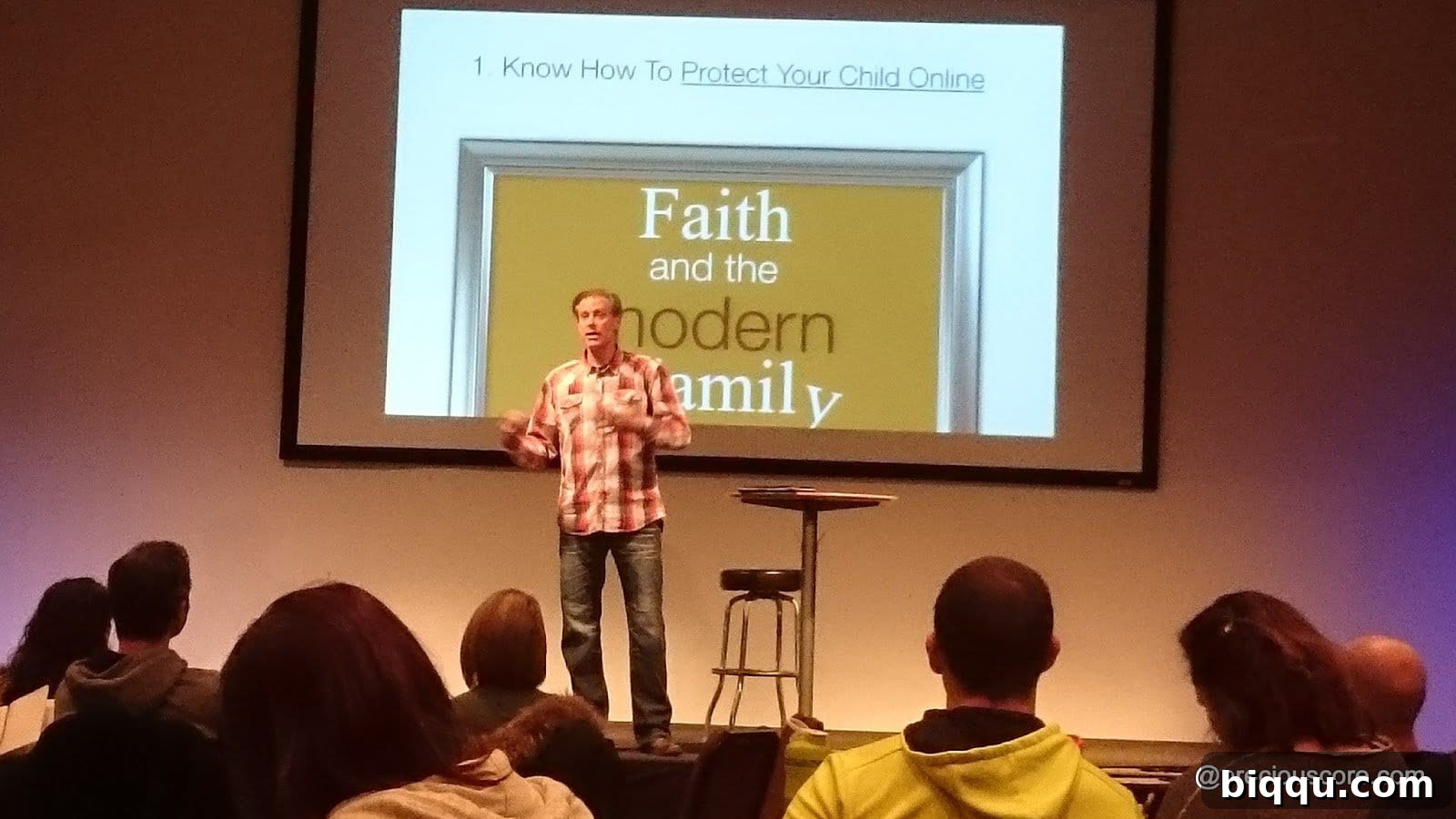 Attendees at the 'Faith and the Modern Family' seminar, actively engaged in a discussion on parenting and values.