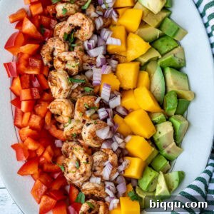 Diced mango, cooked shrimp, avocado, and bell peppers.