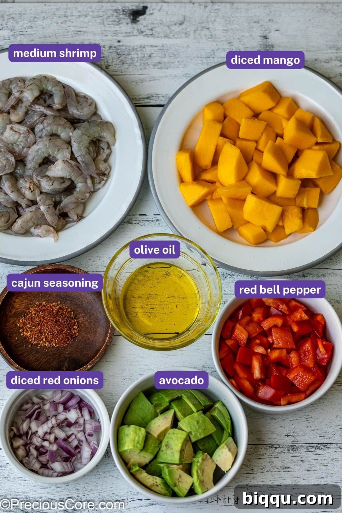Fresh ingredients for a vibrant Mango Shrimp Salad including shrimp, diced mango, avocado, bell peppers, and red onion.