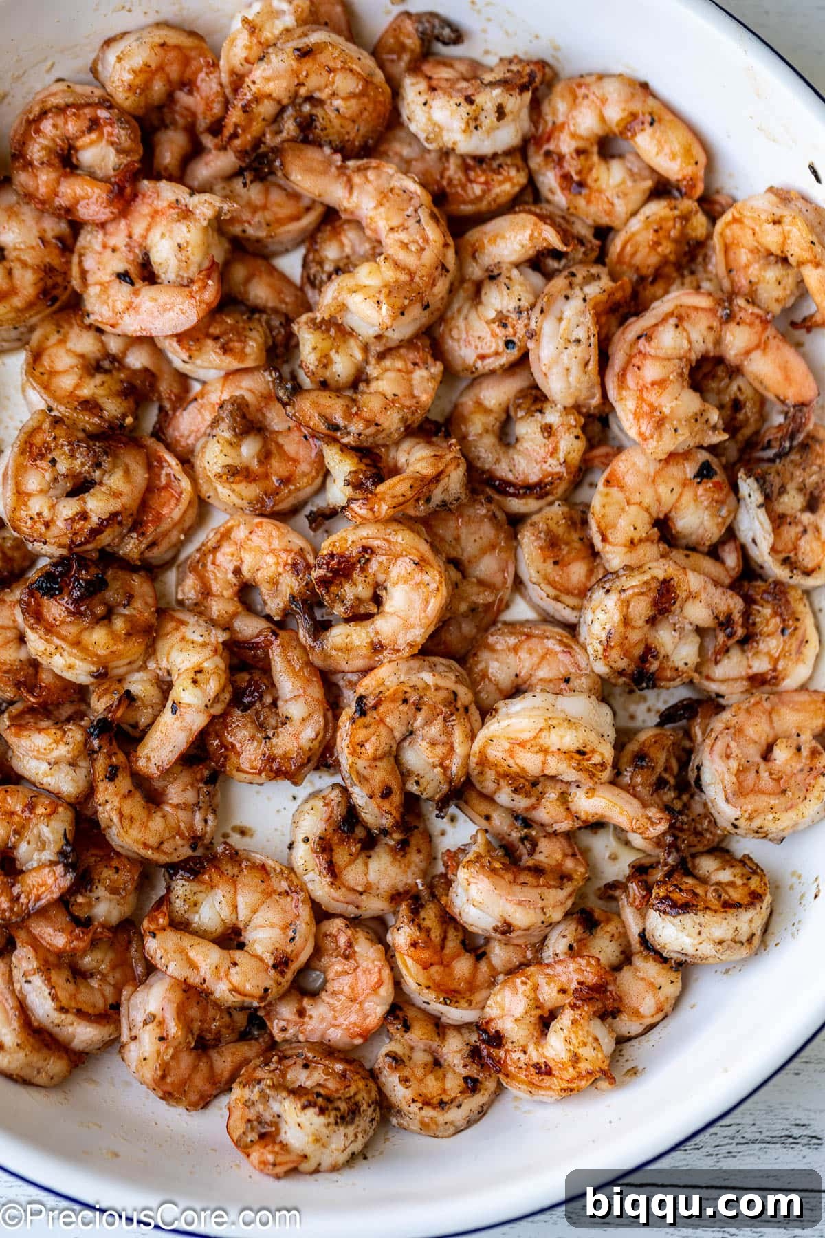 Perfectly seasoned and cooked shrimp neatly arranged in a bowl, ready for the salad.